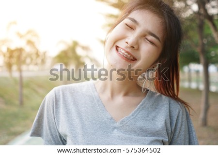 Asian girl smiling in the morning time with  gray shirt.