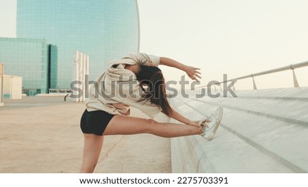 Similar – Young black woman doing stretching after running outdoors