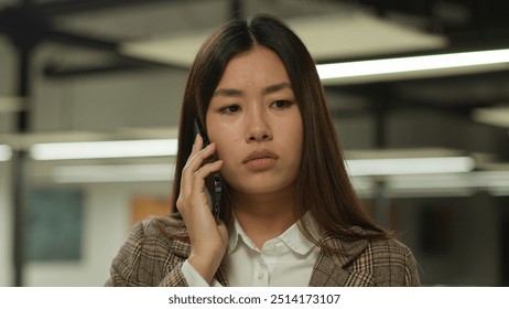 Asian girl student indoors listening bad news mobile phone call worry sad upset failure frustrated Korean business woman Japanese businesswoman Chinese female in office company talk smartphone problem - Powered by Shutterstock