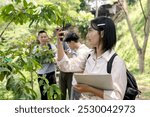 Asian Girl Student Learning And Exploring Nature With Magnifying Glass