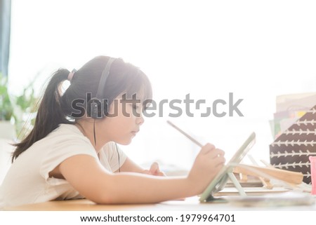 Asian girl student online learning at home.study online video call zoom teacher, kid girl learn english language online with tablet.
