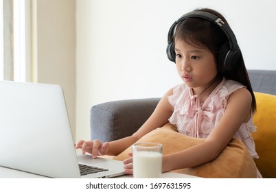 An asian girl is studying from computer. e-learning, homeschooling, social distancing, isolation, quarantine, education, technology, study, online concept