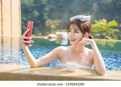 Asian girl take a selfie in the hotspring 