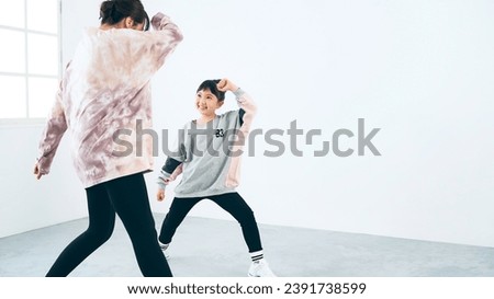 Asian girl and teacher woman practicing dance in studio. brake dance. Braking.