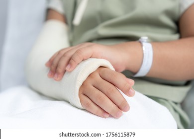 Asian girl treatment in hospital lying on the bed hurting with broken arm back from surgery. - Powered by Shutterstock