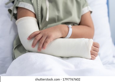 Asian girl treatment in hospital lying on the bed hurting with broken arm back from surgery. - Powered by Shutterstock