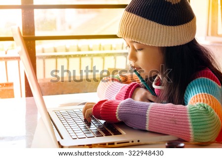 Asian Girl using a laptop.