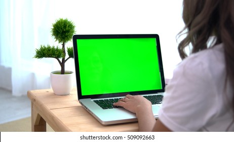 Asian Girl Using Laptop With Green Screen.