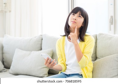  Asian Girl Using Smart Phone, Thinking