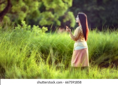 Asian Girl Walking In A Green Rice Farm,Sakonnakhon,Thailand