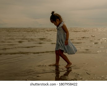 Asian girl walking on the beach in the evening