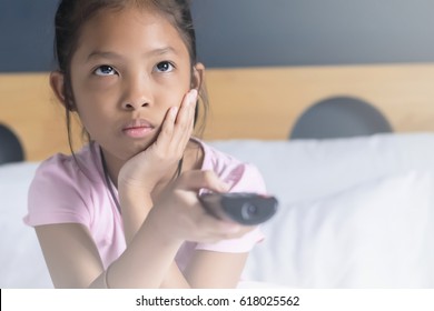 Asian Girl Watching TV On Her Bed