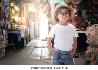 Asian Girl Wearing White T-shirt. Denim Shorts With Glasses And Hats Pose Fashion