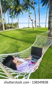 Asian Girl Work In Hammock With Laptop At Bali Beach, Indonesia