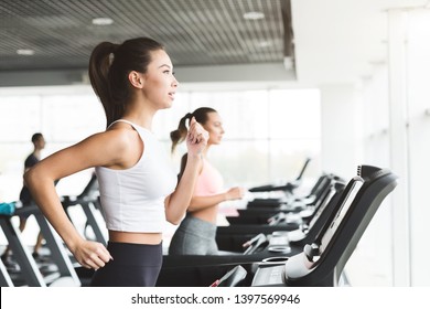 Asian Girl Working Out On Treadmill At The Gym, Side View, Copy Space