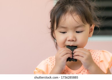 Asian Girls Eating Seaweed Snacks