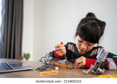 Asian girls enjoy learning online tutor training course at desk table enjoy making and fixing electrical robot car - Shutterstock ID 2114832311