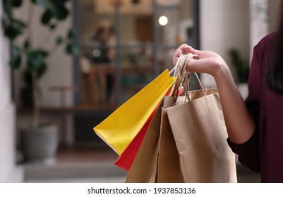 Asian girls holding sale shopping bags.  consumerism lifestyle concept  in the shopping mall