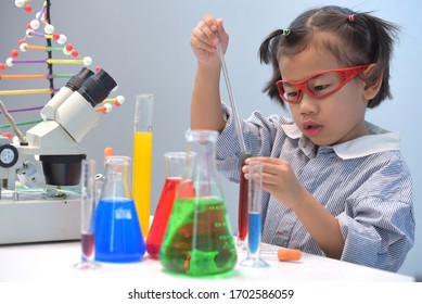 Asian girls on the way to success Science  in the laboratory Chemical research School biology lesson The little girl in the school lab Formal school education Little scientists work with microscopes.