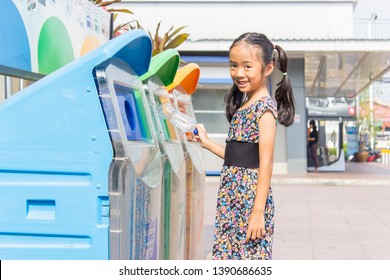 Asian Girls Are Throwing Garbage Into Recyclable Trash. All Ages Must Cooperate To Sort Waste.