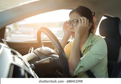 Asian Glasses Business Woman In Green Shirt Having Headache From Migraine While Driving Car With Bad Traffic Jam On Rush Hours. Illness, Exhausted, Disease, Tired For Overtime Working Concept.