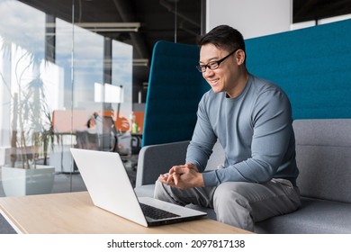 Asian With Glasses, Working In The Office, Making A Video Call With A Laptop, Smiling And Rejoicing, Communicating Remotely With Colleagues Online, Business Man Working In The Office