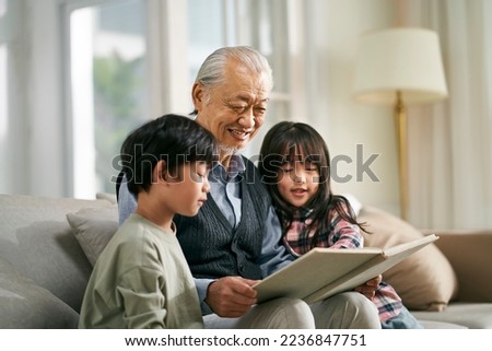 asian grandfather having a good time telling story to cute grandson and granddaughter Stock photo © 