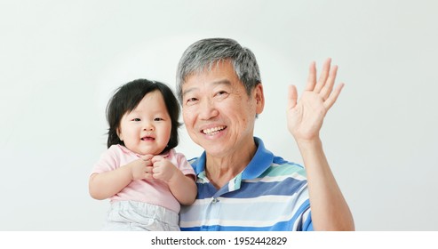 Asian Grandfather Hug His Baby Toddler Granddaughter And Look At You Happily With White Background