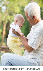 Asian Grandfather Playing With Grandkid