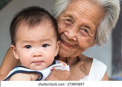 Asian Grandmother With Baby