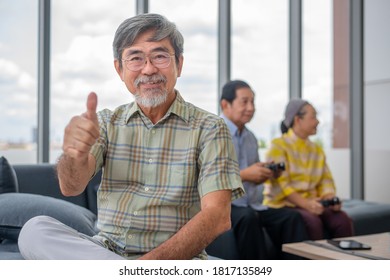 Asian Grandpa Thumb Up With Other Retired On Background