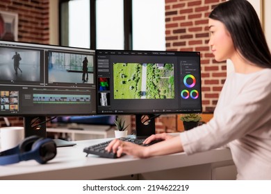 Asian graphic editor working on editing video and audio footage with professional software to create film content for post production. Using movie montage to edit multimedia movie. - Shutterstock ID 2194622219
