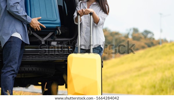 Asian group\
of friends with car travel and suitcase at park in vacation summer\
road trip on holidays. Travel by\
car.