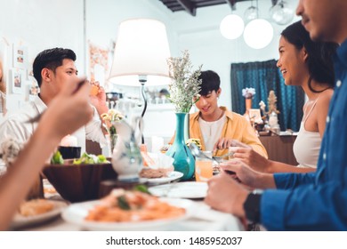 Asian Group; Friends Eating Dinner At Home; They Are Happy To Talk.