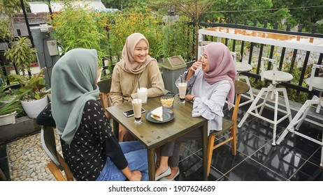 Asian group hijab woman smilling in cafe with friend - Powered by Shutterstock