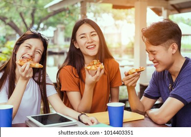 Asian group together eating pizza in breaking time having fun and enjoy party italian food slice with cheese delicious 