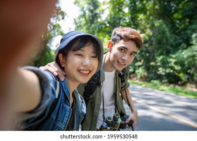 Asian Group Of Young People With Friends And Backpacks Walking Together And Happy Friends Are Taking Photo And Selfie ,Relax Time On Holiday Concept Travel