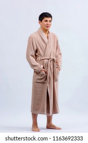 Asian Guy In A Bathrobe. A Kazakh Man In A Dressing Gown On A Light Background.