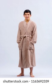 Asian Guy In A Bathrobe. A Kazakh Man In A Dressing Gown On A Light Background.