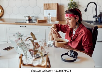 Asian Guy Eating Take Away Noodles While Having Break From Work At Home