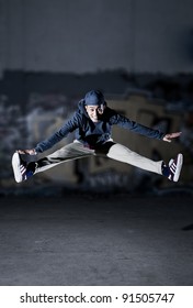 Asian Guy Jumping In Front Of A Grafitti Wall