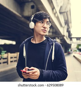 Asian Guy Listen To Music Headphones