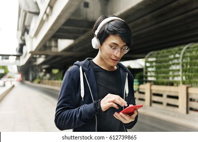 Asian Guy Listening Music By Headphones