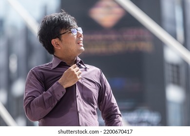 Asian Guy In  With Purple Tshirt Feeling Hot Weather