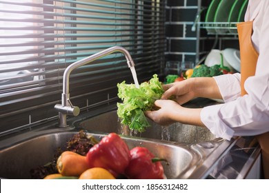 Asian Hands Woman Washing Vegetables Salad And Preparation Healthy Food In Kitchen.