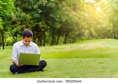 Asian Handsome Business Man Or Student Working On Laptop Sitting On The Backyard In The Garden. Project And Business Concept.