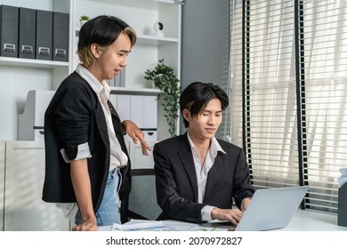 Asian Handsome Businessman Gay People Working In Office With Happiness. Attractive Male Lgbtq Collegues In Formal Wear Sitting On Table, Use Laptop Computer With Gay Pride And Confidence At Workplace.