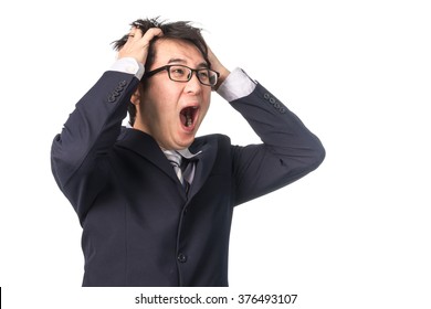 Asian Handsome Businessman Holding His Head Frowning With Worry Screaming. Man Pulling His Hear For Worry, Sadness, Desperation, So Serious, Funny, Isolated On White Background