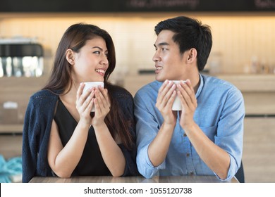 Asian Handsome Man And Beaufitul Girl Drink Coffee In Coffee Shop, Love Couple