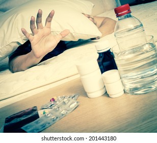 Asian Handsome Man In Bed With Tablets And Water Suffering Insomnia, Hangover And Headache